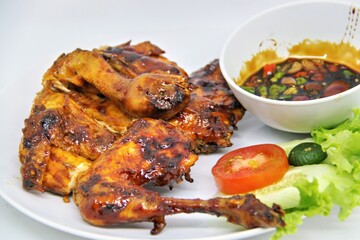 Bakakak Hayam or Ayam Bekakak or Grilled Whole Chicken with seasonings plus soy sauce, a dish from West Java and Jakarta, Indonesia. Usually served to brides at weddings.