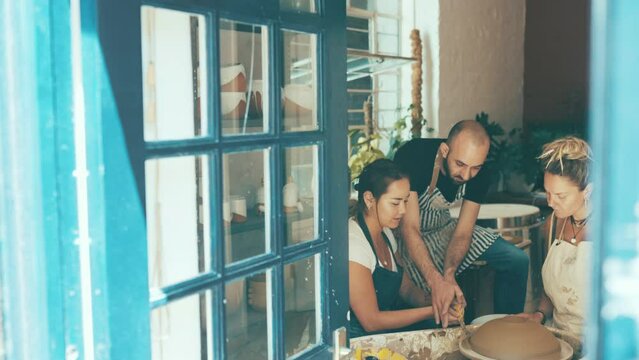 Pottery wheel, class or man teaching workshop skill, sculpture design or teamwork on craftsmanship process. Ceramic studio, teacher or group learning how to mold handmade product, mud creation or art