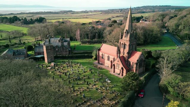 St Bartholomew Church, Thurstaston, Wirral - a quintessential Anglican English Parish Church - Aerial drone clockwise rotate on a sunny morning