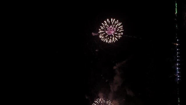 Fantastic fireworks festival at the end of the year near the seafront - vertical video