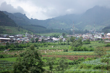 Fototapeta na wymiar Banjarnegara, January 10, 2024 landscape view of residents' houses under the mountain