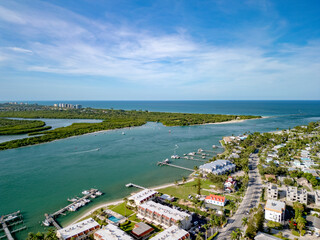 Boat docks leading from riverside resorts and beachside homes at the Fort Pierce Inlet area on South Hutchinson Island in St. Lucie County, Florida, USA. 