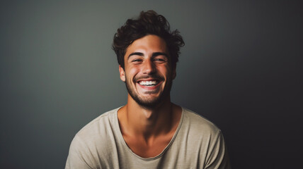 Obraz premium Happy smiling young adult man on a solid background