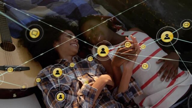 Animation of network of connections with icons over diverse couple in car