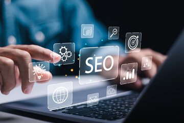 Businessman use laptop to analyze SEO search engine optimization for promoting ranking traffic on website and optimizing your website to rank in search engines. - obrazy, fototapety, plakaty