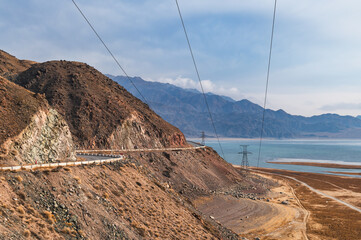 Electrical towers supporting high voltage power lines in remote mountainous areas of Kyrgyzstan.