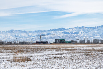 Construction of industrial facilities in a mountain valley. Industrialization, destruction of the natural environment.