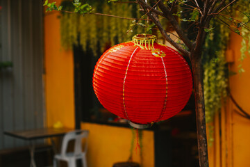 Red Chinese lantern close-up on Yellow Wall Background