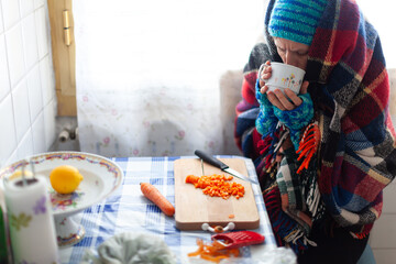 Mid Adult Female Unemployed Preparing herself a Poor Vegetable Meal in an Old Cold Apartment - Poverty Social Issues