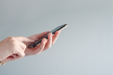 Women hand using smartphone typing or chatting conversation on internet networking. Technology, Communication and Social media marketing concept.