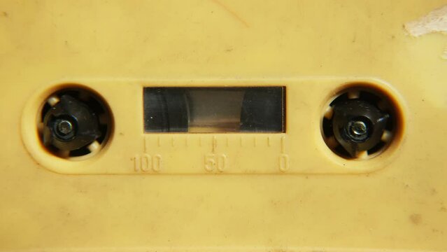 Old music audio player. Rotating tape on an old vintage cassette. Retro music concept.