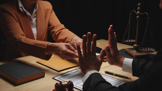 Businesswomen offer bribes to lawyers To help with legal matters in court, bribes corruption illegal fraud bribery concept.