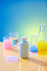 Close up of an unlabeled cosmetic bottle placed in the center of the frame, surrounded by glass laboratory flasks containing colored solutions. Outstanding gradient background.