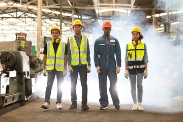 portrait group of engineers or workers standing and walking in the factory