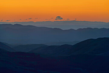sunset over layers of mountains, sunrise, silhouette