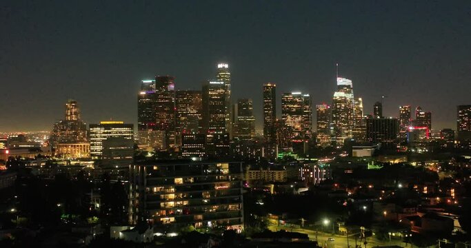 Scenic aerial view of skyscrapers in Los Angeles city at night. Illuminated buildings in Los Angeles skyline, Aerial drone shot, Los Angeles, California. Skyline towers in LA.