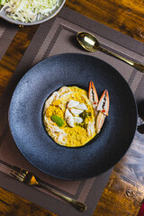 Khanom Jeen, food that has noodles as the main ingredient. Crab meat noodles on a black dinner plate, looking elegant.