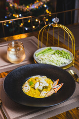 Khanom Jeen, food that has noodles as the main ingredient. Crab meat noodles on a black dinner plate, looking elegant.