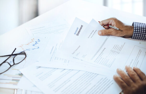 Asian businessman reviewing bank statement and bank account at office to apply for a business investment loan, check credit and plan borrowing to investment