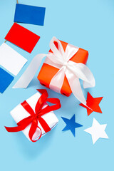 Gift boxes with garland and stars on blue background. American Independence Day