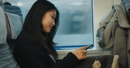 Japanese woman, travel and train on cellphone, social media and public transportation on metro...