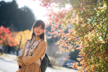 Casual dress elegance, Asian woman explores Kyoto's fall beauty, capturing cheerful smiles amid...
