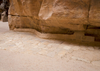 Remains of stone pavement and the drainage channel is cut into the wall in continuation of the...