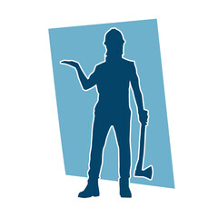Fototapeta premium Silhouette of a worker in action pose using his axe tool.