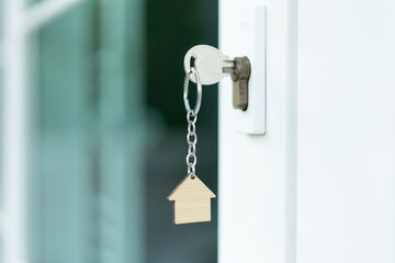 Landlord key for unlocking house is plugged into the door. Second hand house for rent and sale. Owner use hand unlock door mortgage for new home, buy, sell, renovate, investment, owner, estate
