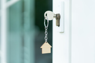 Landlord key for unlocking house is plugged into the door. Second hand house for rent and sale. Owner use hand unlock door mortgage for new home, buy, sell, renovate, investment, owner, estate