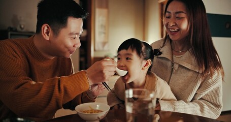 Food, home and Japanese parents and child at table for lunch, breakfast and eating meal together. Happy family, culture and mother, father and young girl in house for bonding, relationship and love - Powered by Adobe