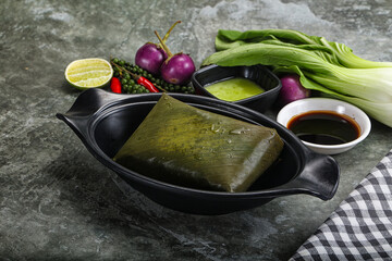 Asian cuisine - rice with filling in banana leaf