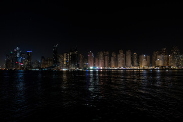 Fototapeta premium City at night, panoramic scene of downtown reflected Dubai