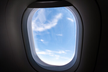 View of the clouds through the porthole.. window of airplane