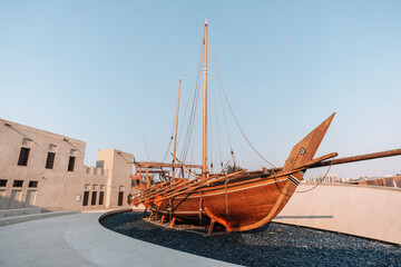 Old wooden rowing boat at historical are of Dubai. Boat installation.