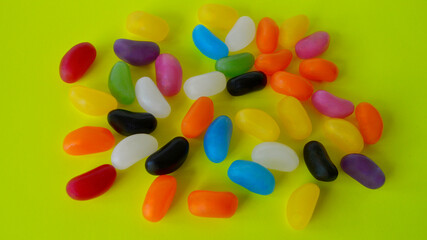 Jelly beans against a colorful background.