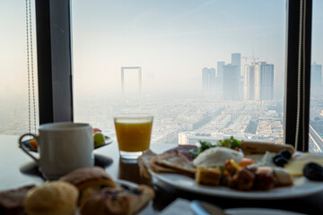breakfast at hotel with Arabic food on the background of a beautiful view of the sights of Dubai. Beautiful view from the restaurant window.