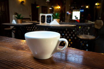 Coffee cup on the table. Hot Coffee Cup on Wood Table in blurred Coffee Shop background.