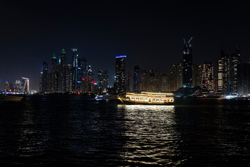Obraz premium dubai marina night cruise. Luxury yachts in night lights on the water.