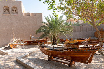 Old wooden rowing boat at historical are of Dubai. Boat installation.