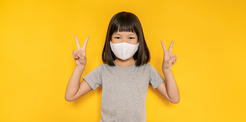 Portrait of asian little girl wearing mask protect from corona virus pm 2.5. Asia toddler girl wearing surgical face mask against flu disease, epidemic virus social distancing, back to school concept - obrazy, fototapety, plakaty