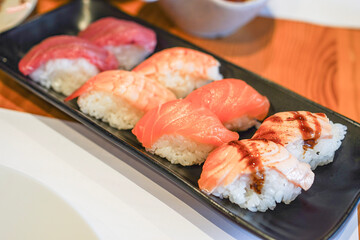 Assorted sushi plate with salmon and tuna nigiri.