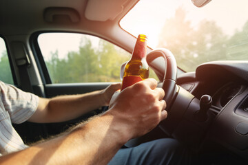 Naklejka premium Man drunk driving car. Have a beer or liquor bottle on hand. Risks and dangers of road accidents. Soft focus and blurred.