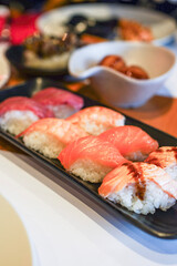 Assorted sushi plate with salmon and tuna nigiri.