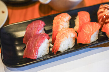 Assorted sushi plate with salmon and tuna nigiri.