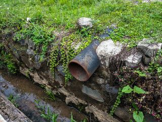water drainage pipe from the street to the ditch