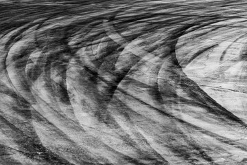 Tire track mark on asphalt tarmac road race track texture and background, Abstract background black tire tracks skid on asphalt road in racing circuit, Tire mark skid mark on asphalt road.