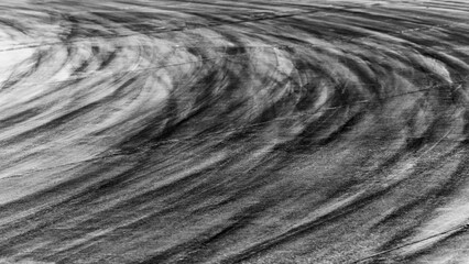 Tire track mark on asphalt tarmac road race track texture and background, Abstract background black tire tracks skid on asphalt road in racing circuit, Tire mark skid mark on asphalt road.