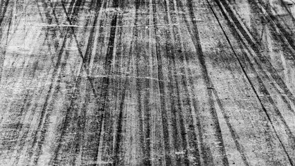 Fototapeta premium Tire track mark on asphalt tarmac road race track texture and background, Abstract background black tire tracks skid on asphalt road in racing circuit, Tire mark skid mark on asphalt road.