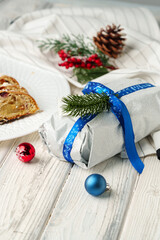 Christmas stollen on plate on white wooden table